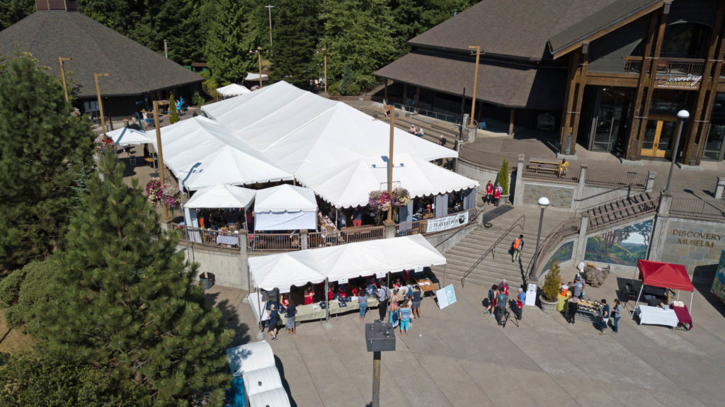Drone view of an event set up under large white tents