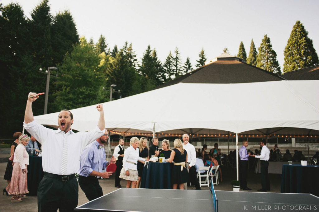 Man celebrates a point at a ping pong table
