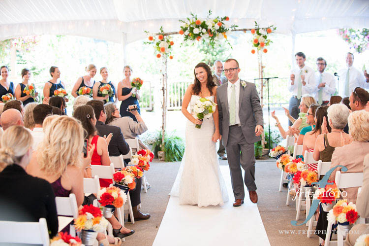 Bride and groom walk down the aisle at wedding ceremony