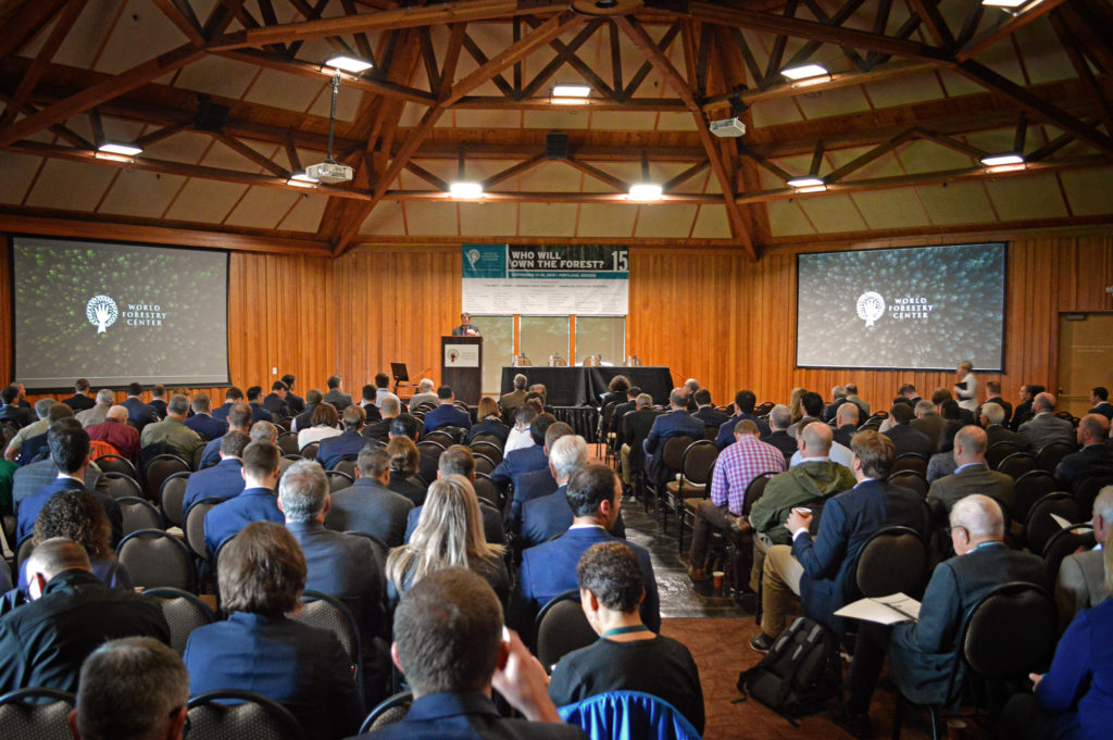 Large group of people watch a lecture and visual presentation